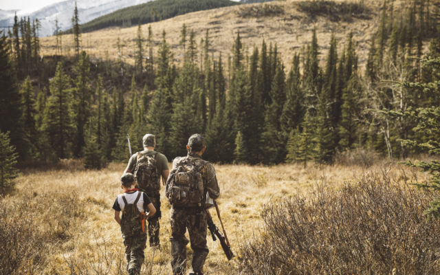 hunters walking in field